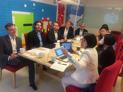 Modern classroom with students using tablets and interactive whiteboard, technology enhanced learning environment